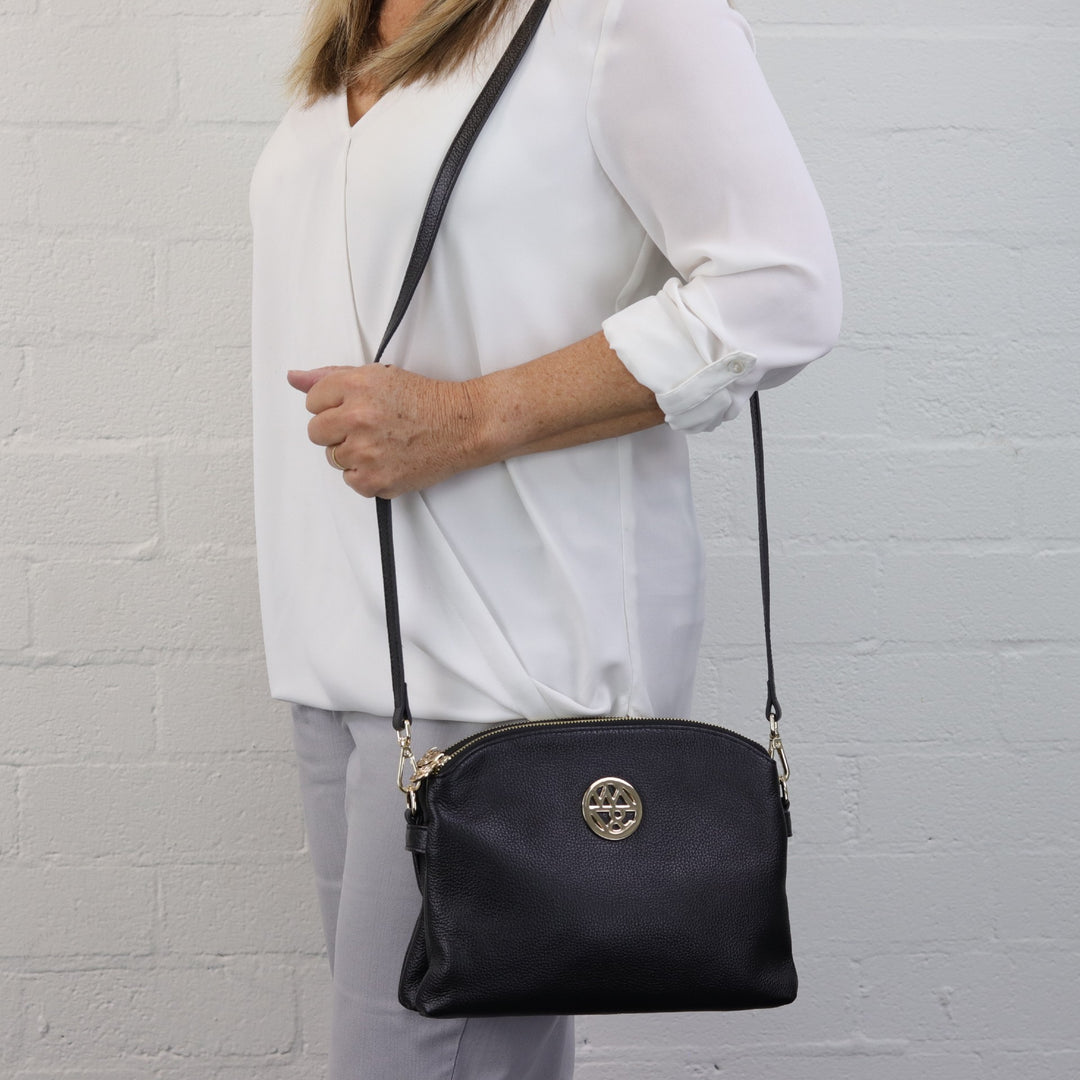 model wearing black Abigail bag on shoulder #colour_black