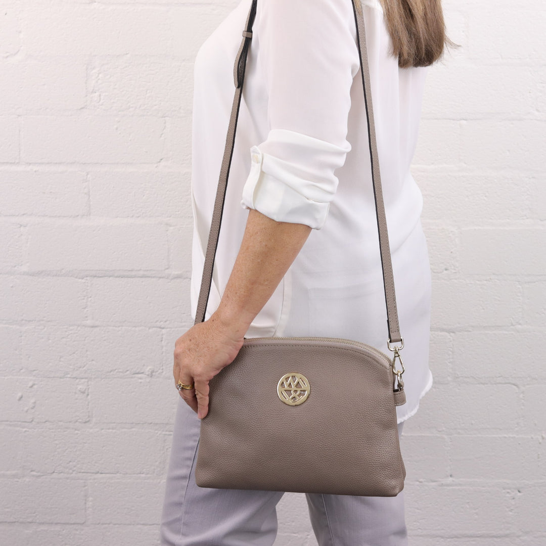 lady wearing the abigail style in a light brown colour on shoulder #colour_fog