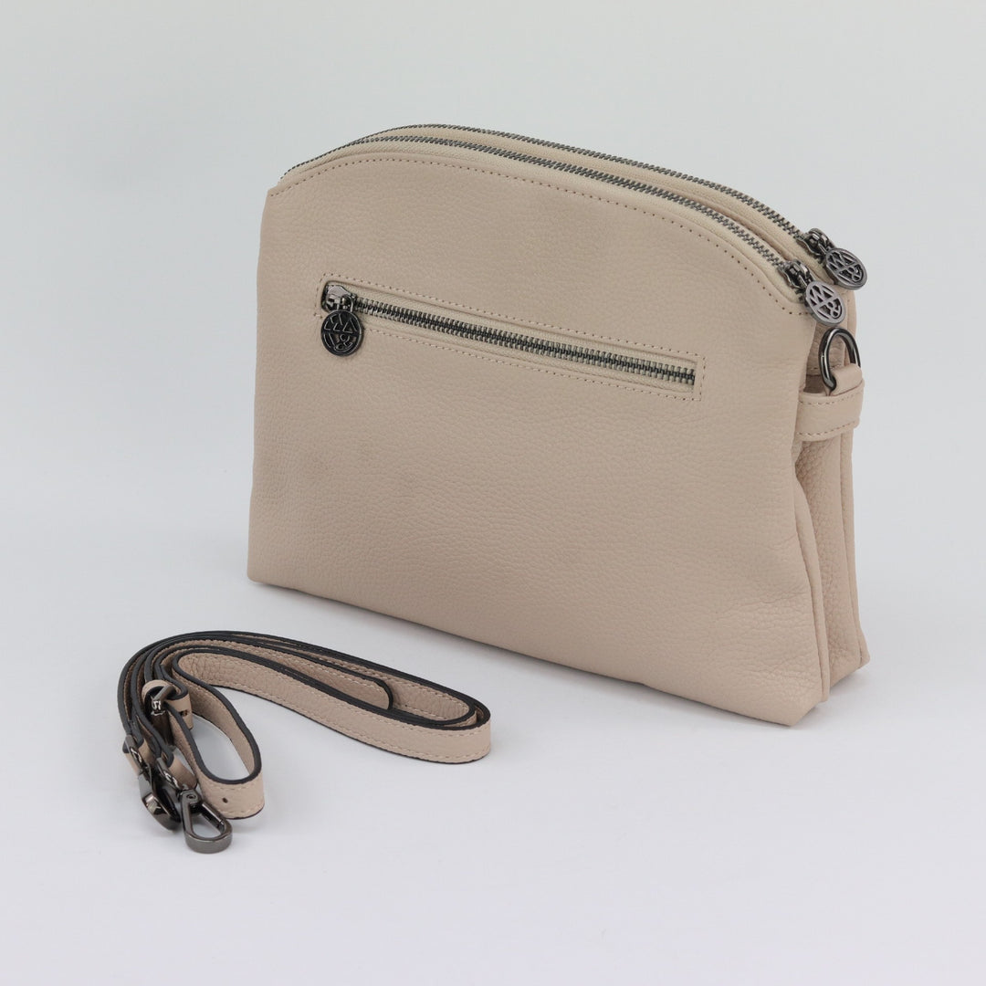 back of nude Abigail bag showing silver zip and spare strap#colour_nude-black-hardware