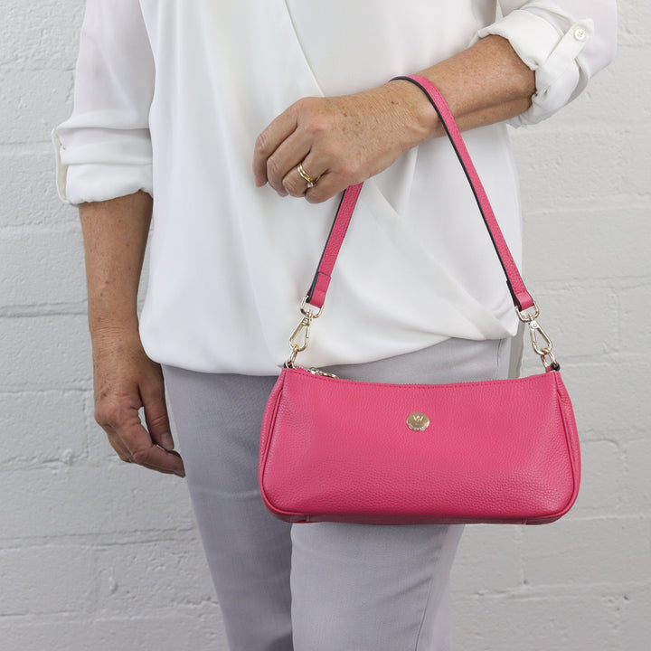 bronte baguette bag in fuchsia worn on arm#colour_hot-pink