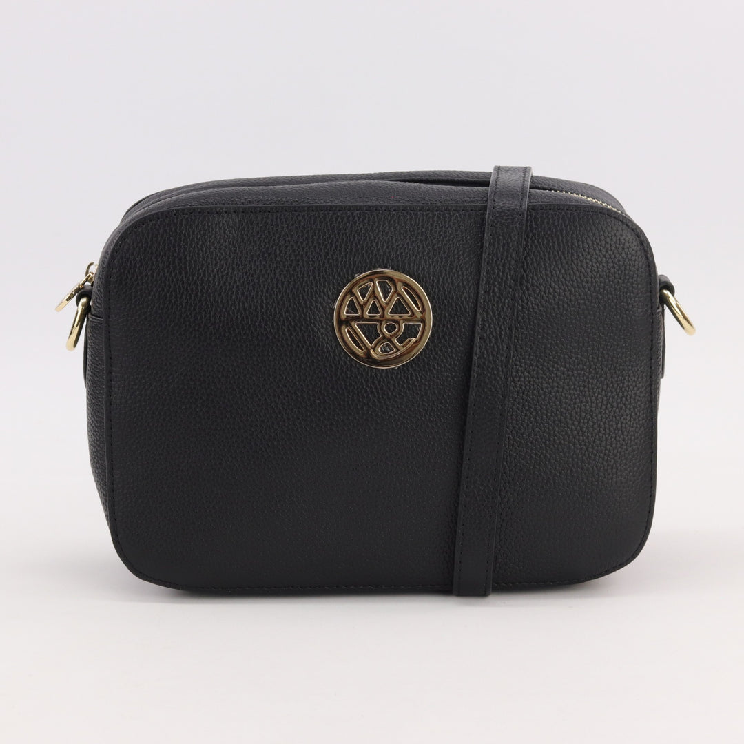 camera bag style bag in black pebbled leather with gold badge logo and long adjustable strap#colour_black