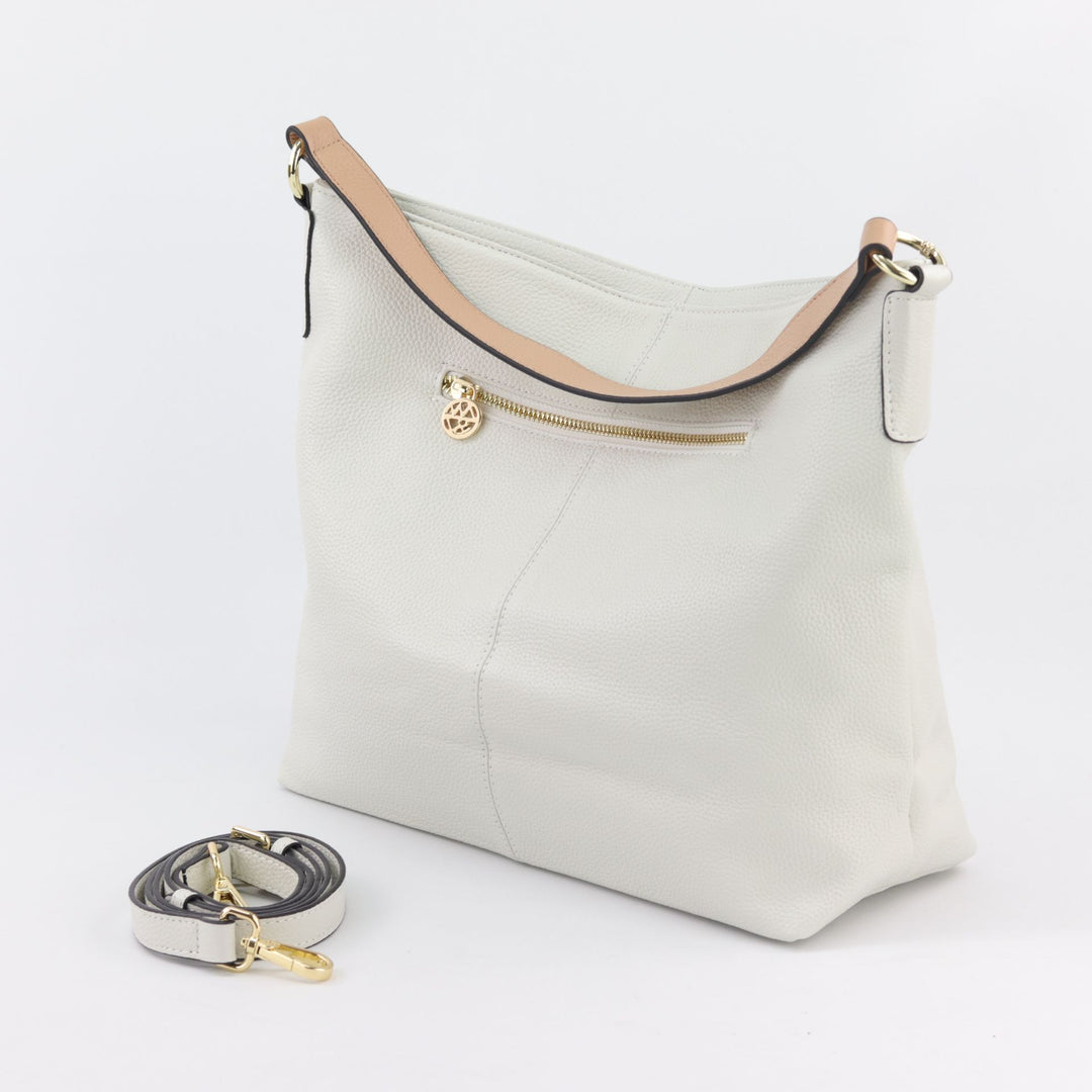 back view of amber hobo in white sandstone leather with included leather crossbody strap #colour_white-sandstone