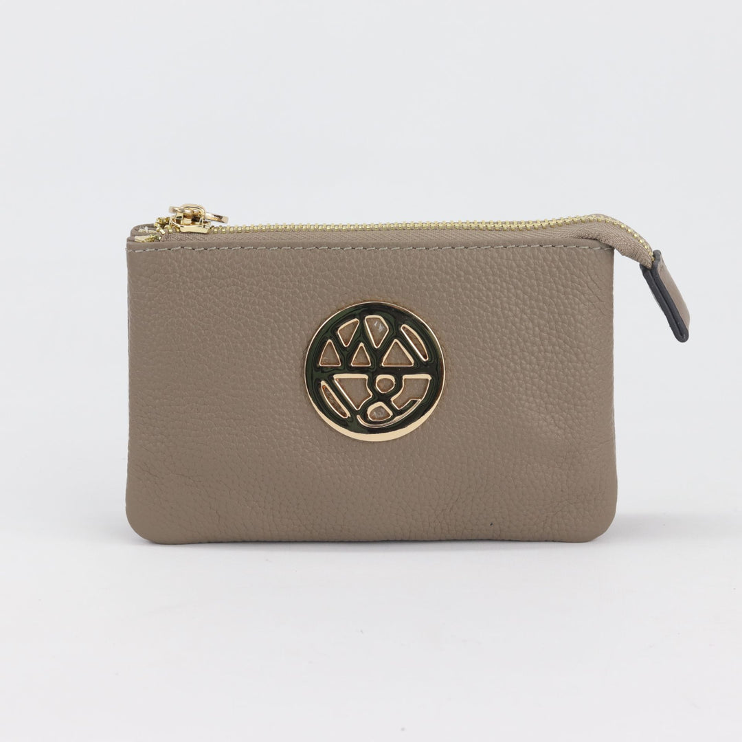 fog brown coloured wallet or small pouch with round logo badge and gold zip closure#colour_fog