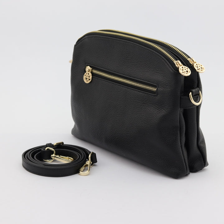 rear view of black leather with crossbody strap and gold zipper#colour_black