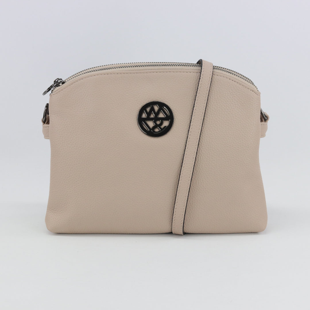nude coloured pebbled leather handbag with gunmetal badge logo#colour_nude-black-hardware