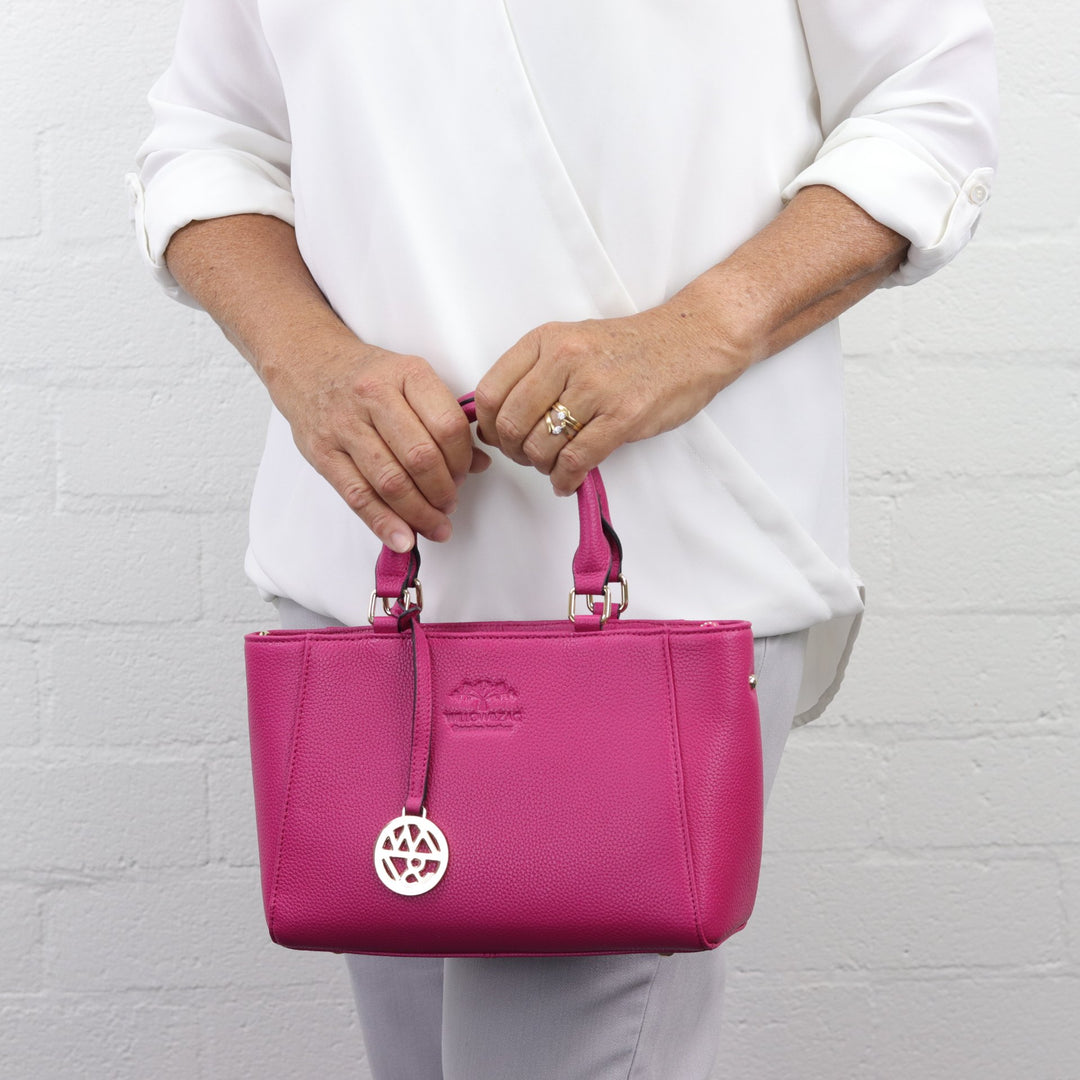 lady wearing Willow and Zac small handbag anika in fuchsia leather #colour_fuchsia