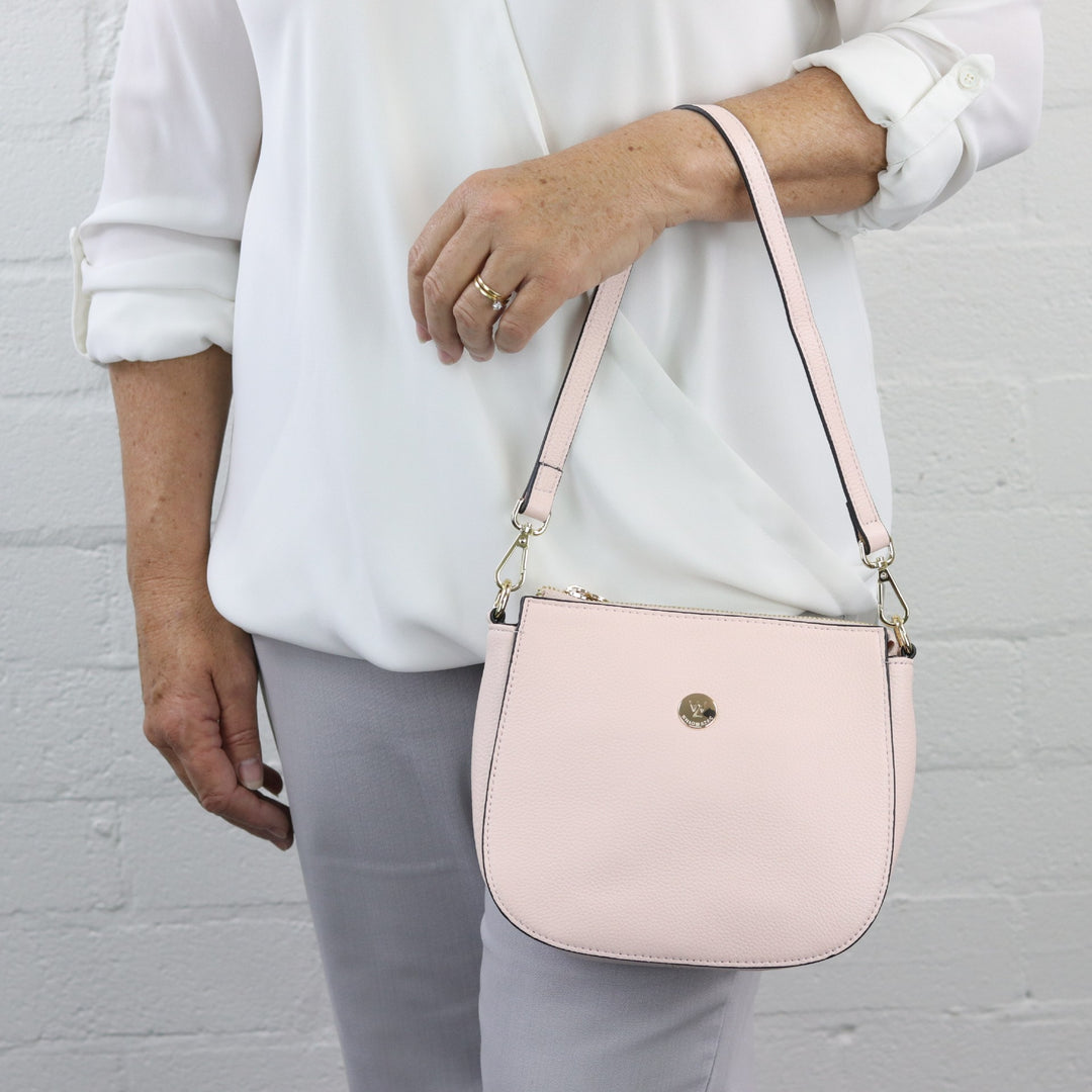 pale pink pebbled leather handbag with leather shoulder strap#colour_pink-whisper