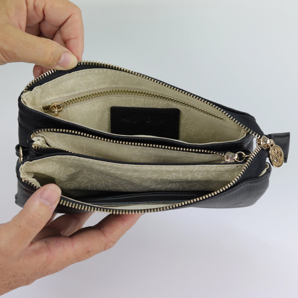 inside view of evie 5 pocket clutch showing internal layout with pockets and gold zips#colour_black-cosmos