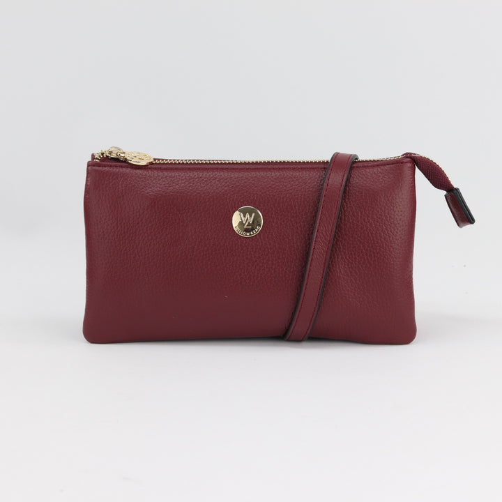 maroon shiraz coloured pebbled leather handbag clutch with long leather strap for across body wear#colour_shiraz