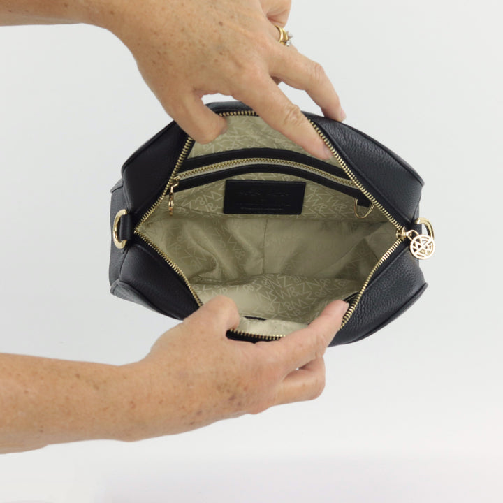 interior image of freida camera style bag with interior and exterior pockets#colour_black