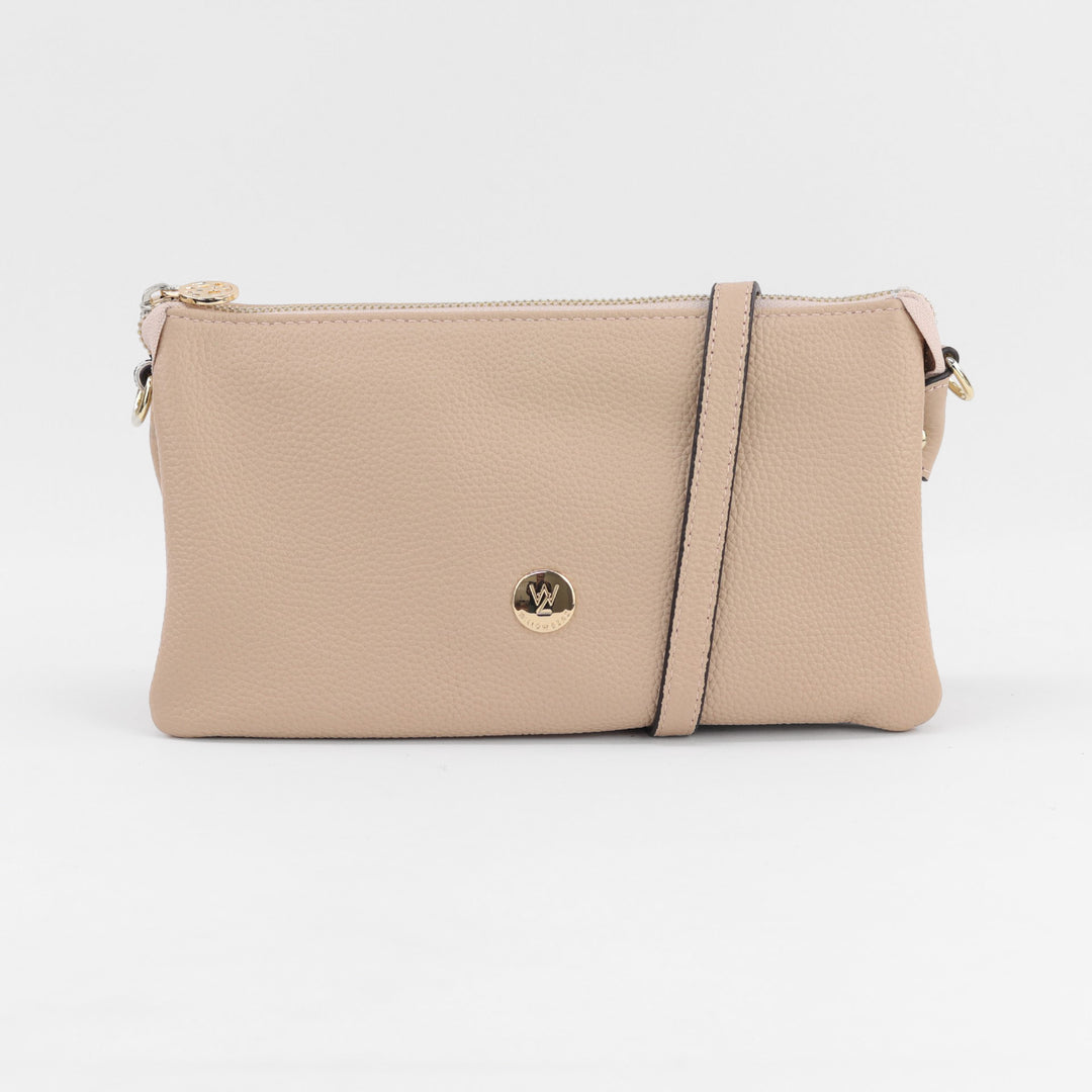 neutral nude coloured leather gracie clutch handbag with long strap and gold zips and button logo#colour_nude