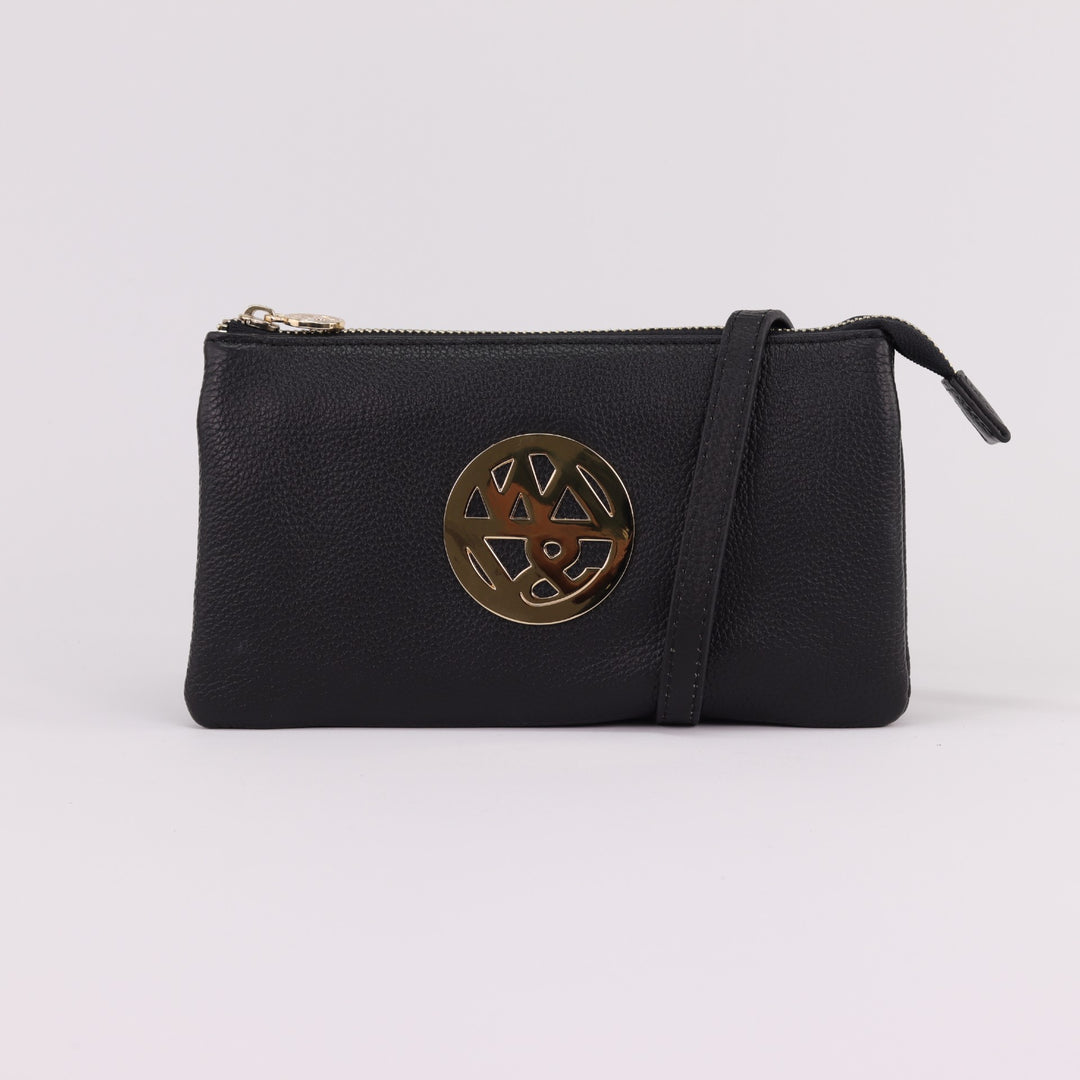 black coloured leather wallet clutch with large round logo badge in gold and optional long crossbody strap#colour_black
