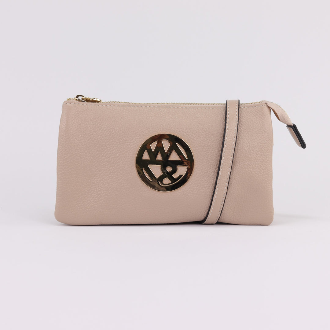 neutral nude coloured leather wallet or clutch with gold badge logo and zip with optional cross body strap#colour_nude