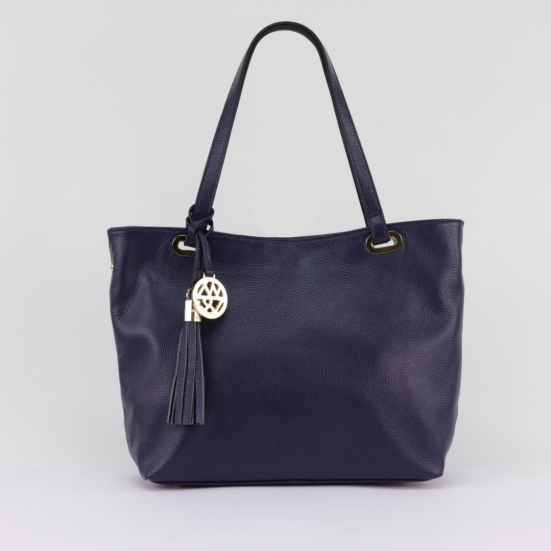 Kiera leather tote in navy pebbled leather with removable tassel and gold logo charm on handles#colour_navy