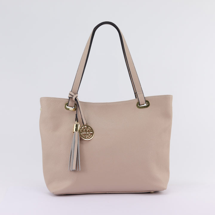 neutral nude coloured pebbled leather tote bag with tassle and charm logo#colour_nude