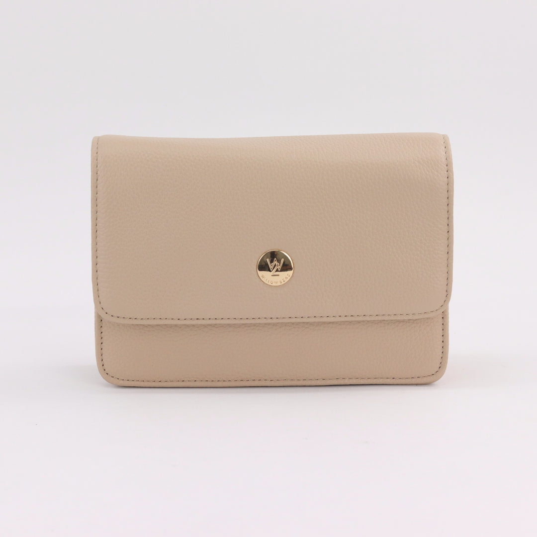 compact messenger style clutch or crossbody bag in neutral nude coloured pebbled leather with gold button logo#colour_nude