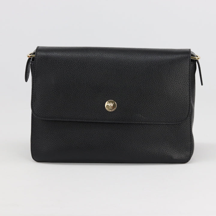 front view of louise handbag in black leather with small button logo and flap closure#colour_black
