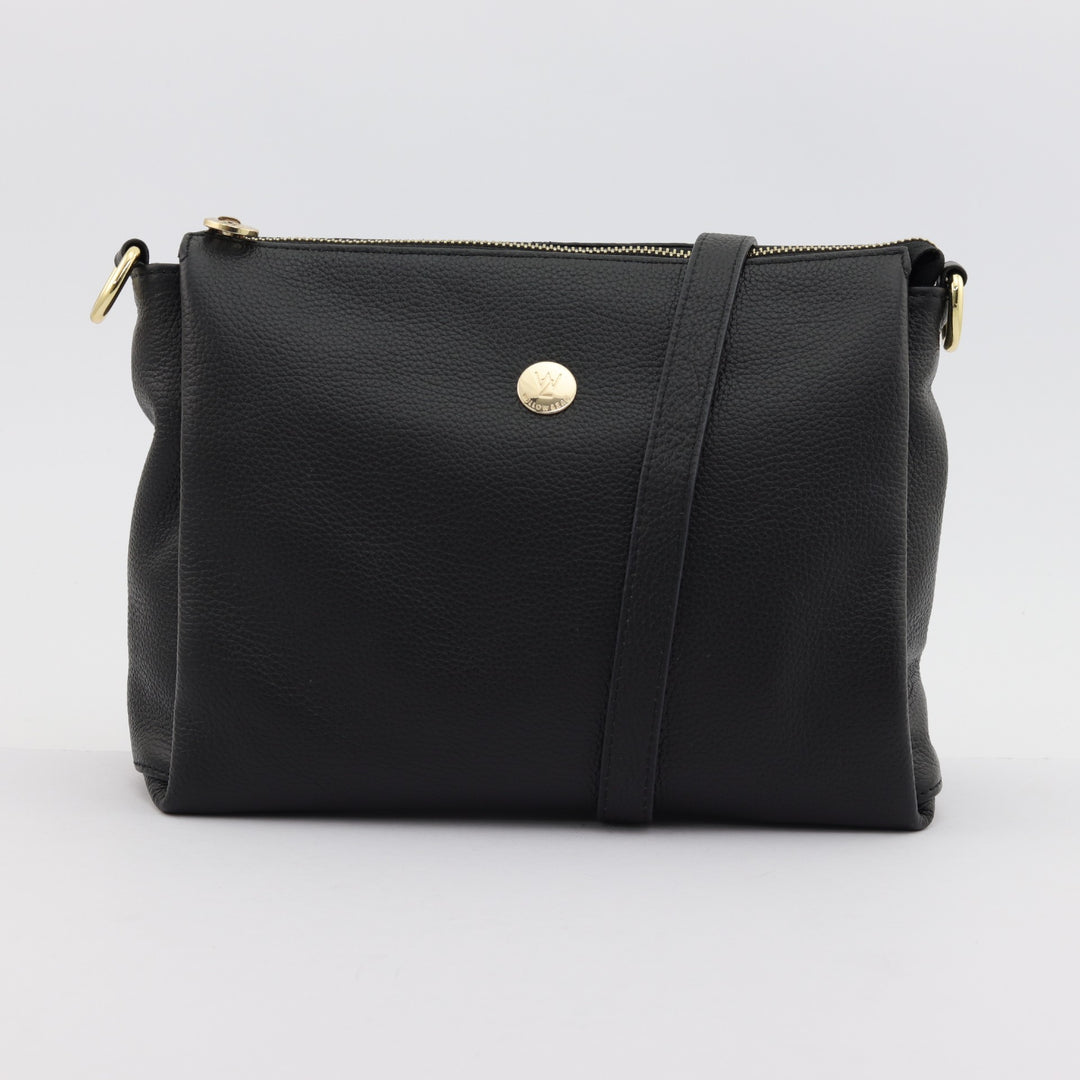 nina in black pebbled leather with small gold button logo and long and short leather strap options#colour_black