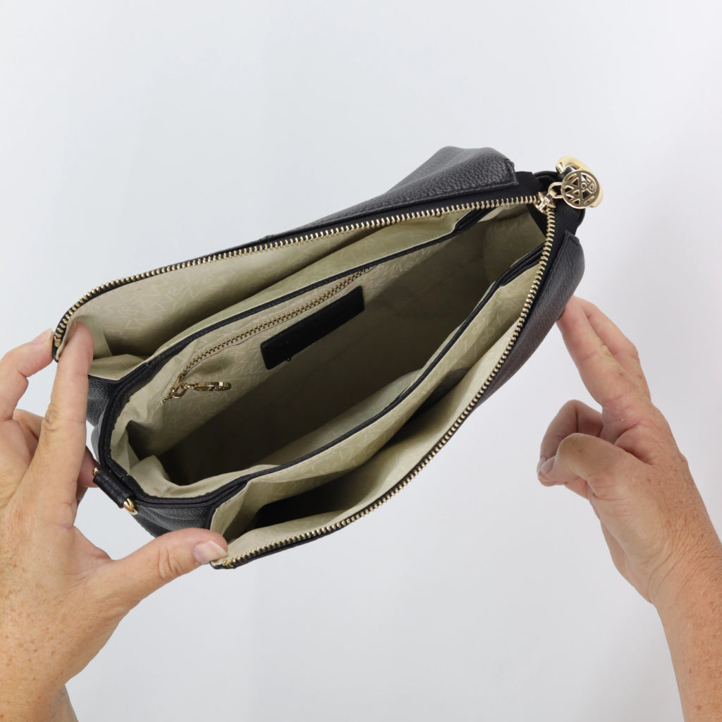 inside view of nina hand bag showing 3 internal compartments with zip and slip pockets with gold hardware#colour_ash