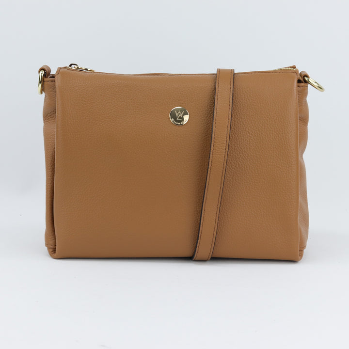 front view of nina bag in caramel tan coloured pebbled leather with long and short leather strap options#colour_caramel