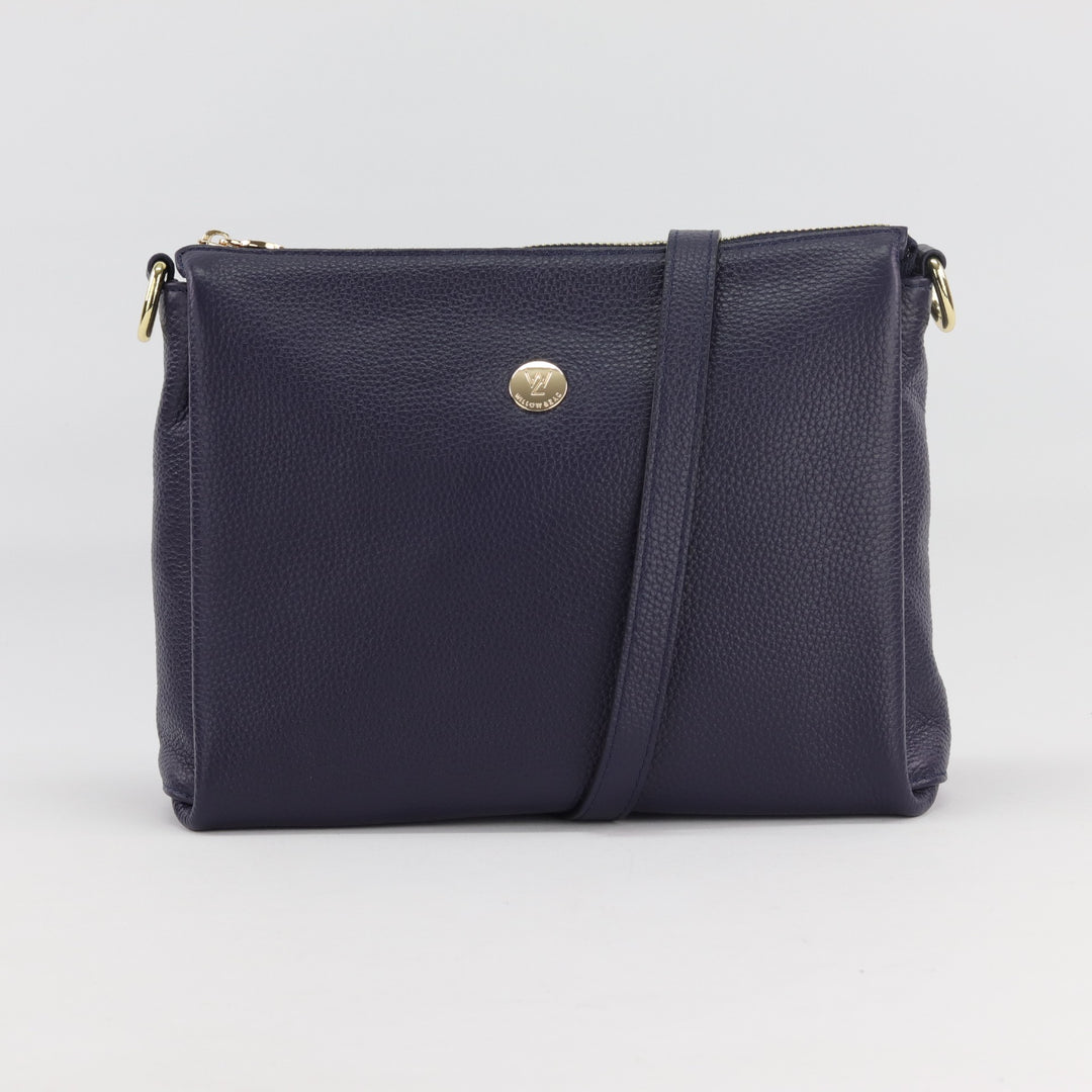 navy blue pebbled leather bag with wide base and gold zip closure finished with gold zip and button logo#colour_navy