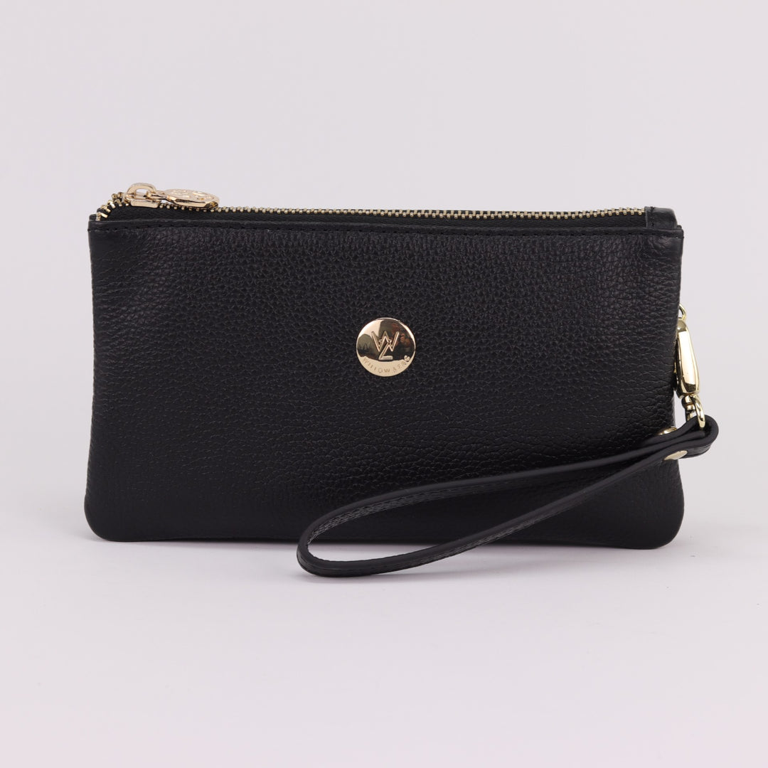 black leather clutch with gold badge logo and removable wrist strap#colour_black