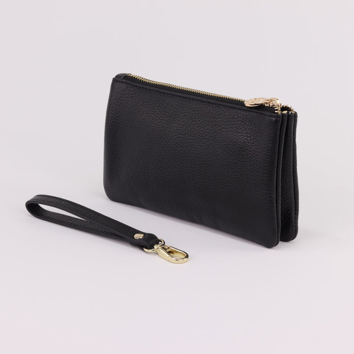 back view of polly leather clutch with detachable wrist strap and gold hardware #colour_black
