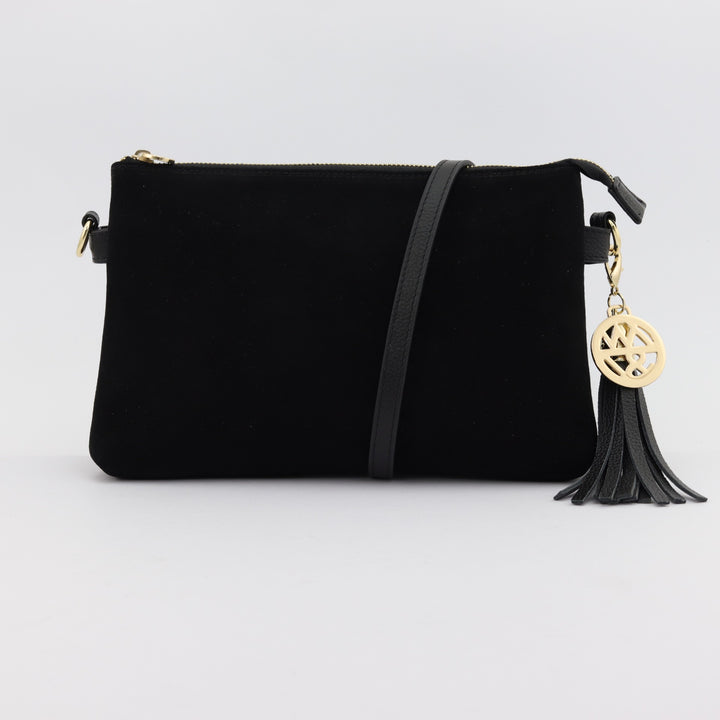 ruby black leather handbag with black suede front panel and optional long leather strap with tassel and logo charm#colour_black-suede