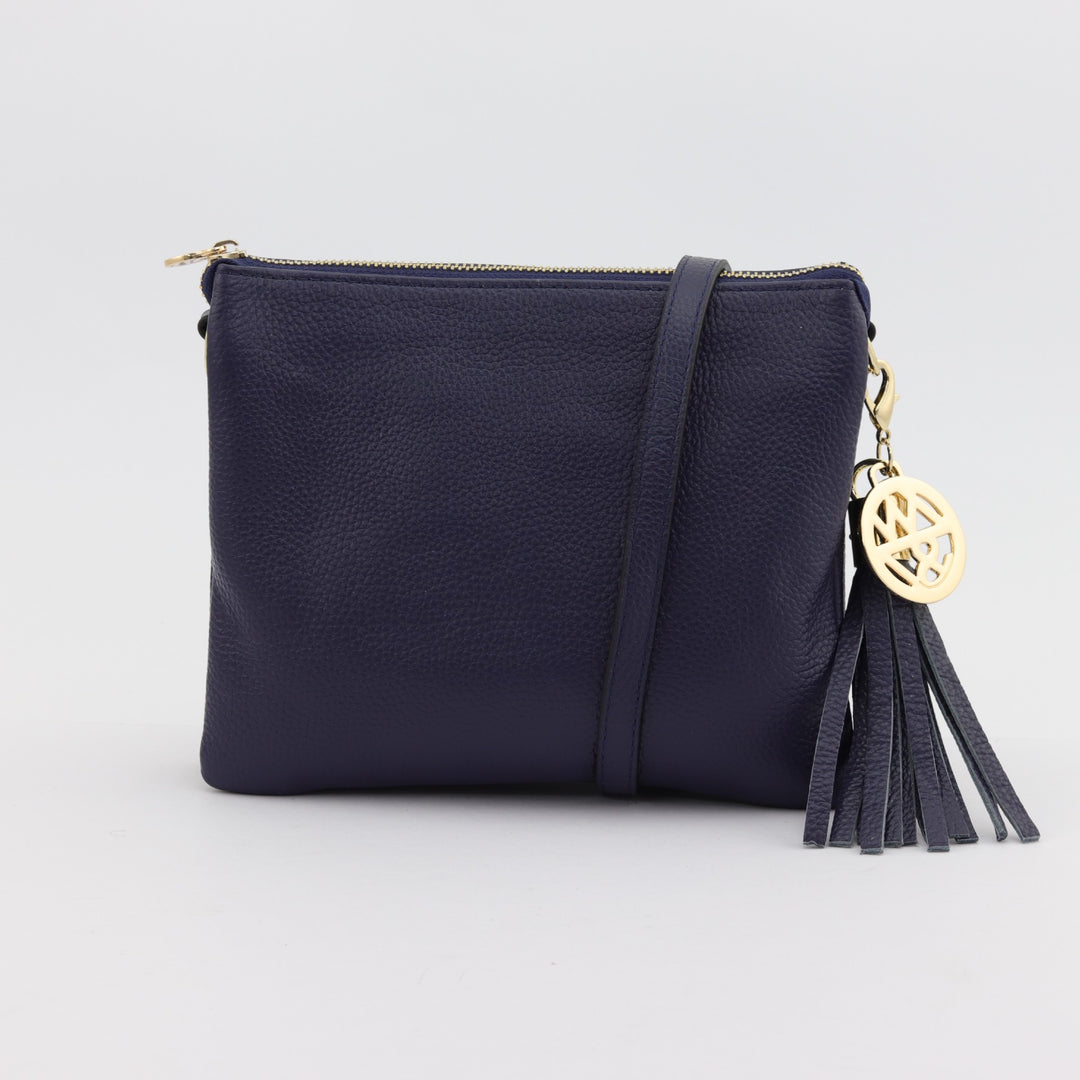 tara square leather handbag in navy blue with cross body strap and tassel with gold hardware#colour_navy
