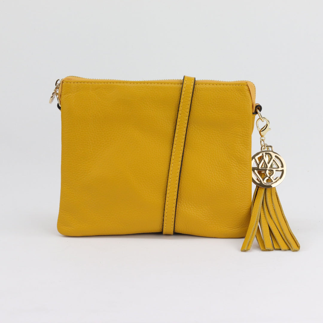 bright yellow quality leather handbag or clutch with optional long cross body strap and removable tassel#colour_saffron