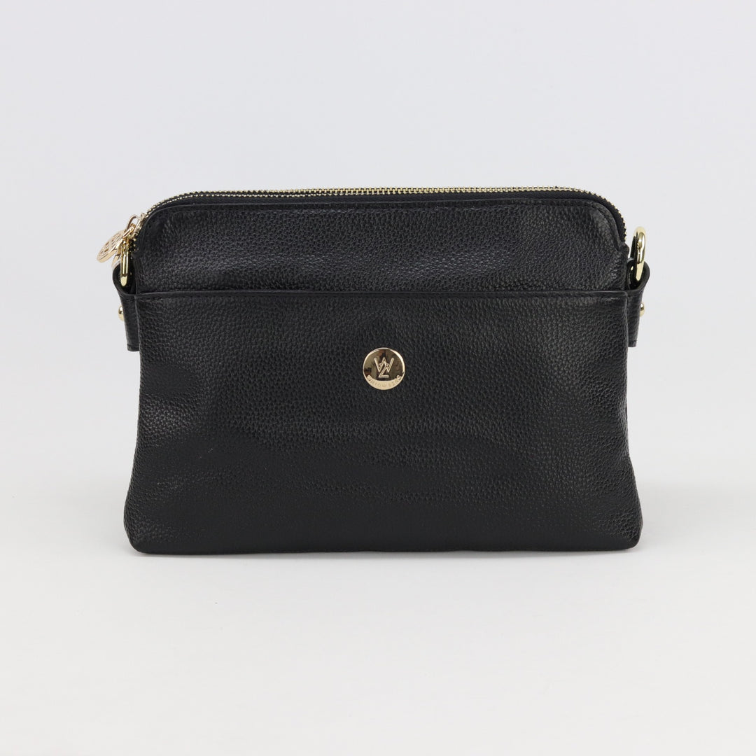 australian designed trisha leather handbag in black pebbled leather with front pocket and small gold logo button and zips#colour_black