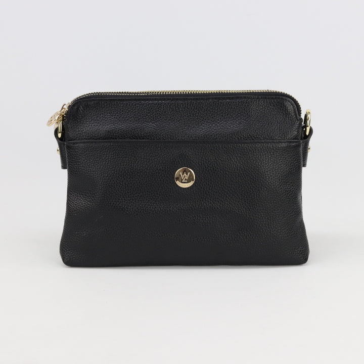 australian designed trisha leather handbag in black pebbled leather with front pocket and small gold logo button and zips#colour_black