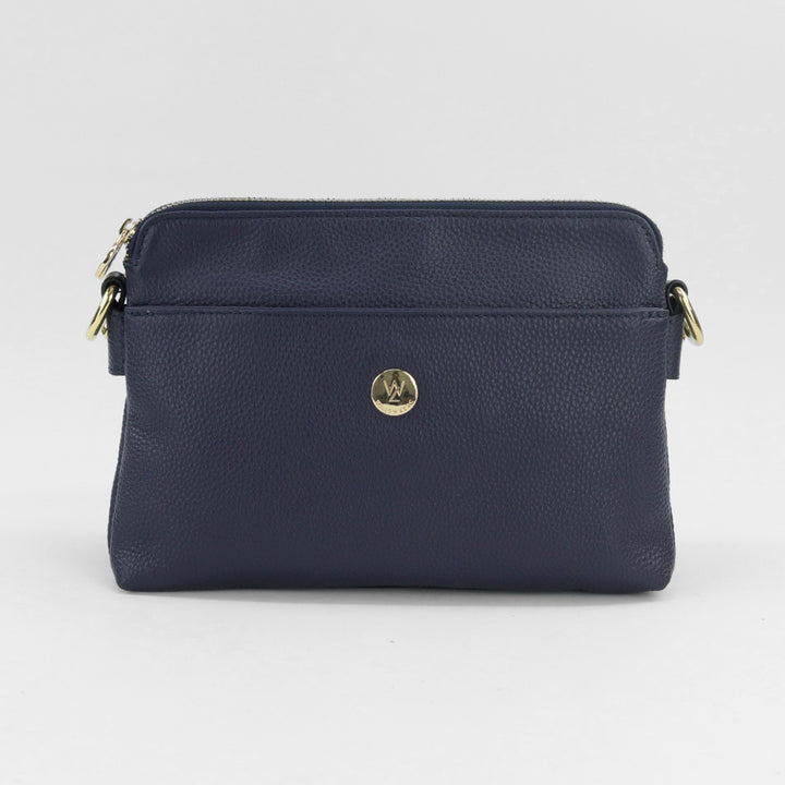 navy blue coloured curved top crossbody style handbag with included long leather strap and quality gold hardware#colour_navy