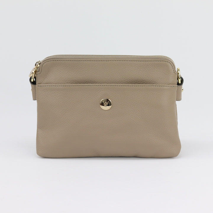 neutral light brown coloured leather handbag with curved top and included cross body strap and gold hardware from australian small business#colour_taupe