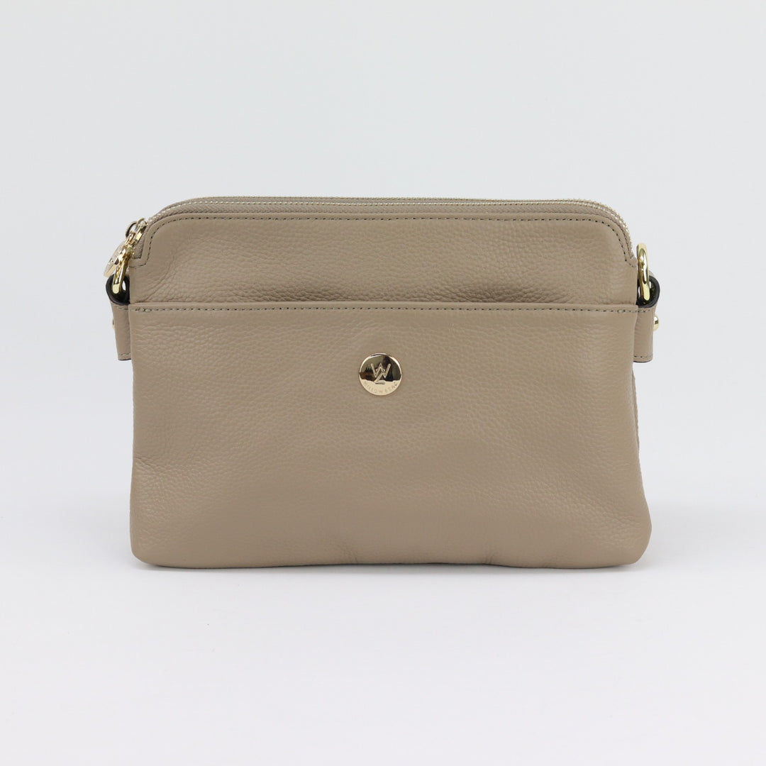 neutral light brown coloured leather handbag with curved top and included cross body strap and gold hardware from australian small business#colour_taupe